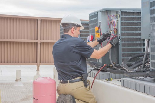 technician working on ac unit